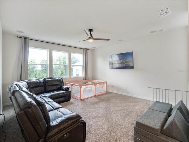 living room with ceiling fan and carpet floors