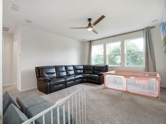 carpeted living room with ceiling fan