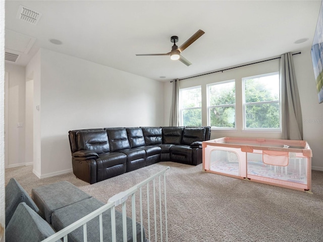 living area with carpet floors, visible vents, and ceiling fan