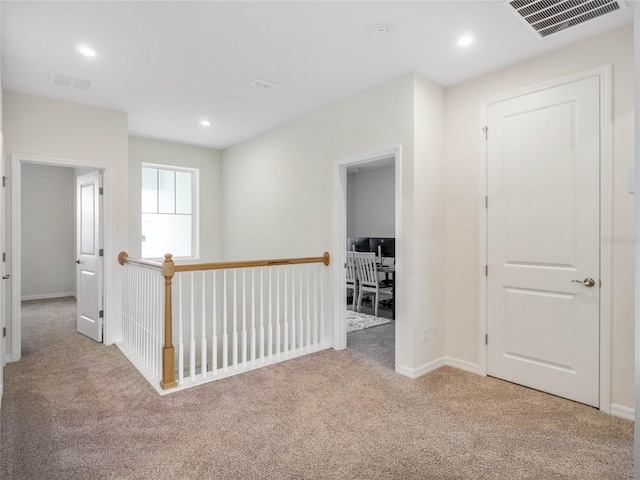 hall featuring baseboards, visible vents, carpet flooring, and recessed lighting