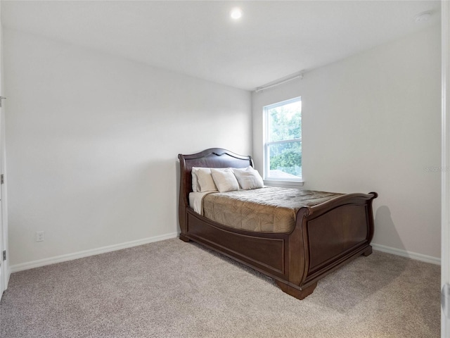 bedroom featuring light carpet