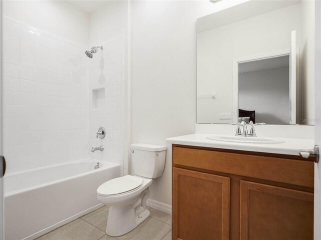 full bathroom featuring tiled shower / bath, vanity, toilet, and tile patterned flooring