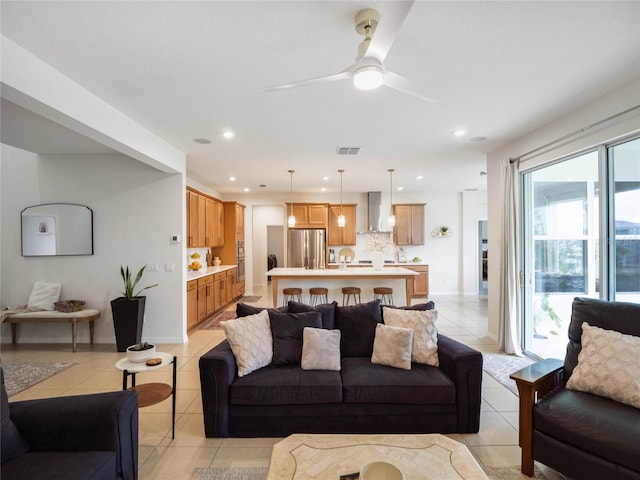 living room featuring a ceiling fan, recessed lighting, visible vents, and light tile patterned floors