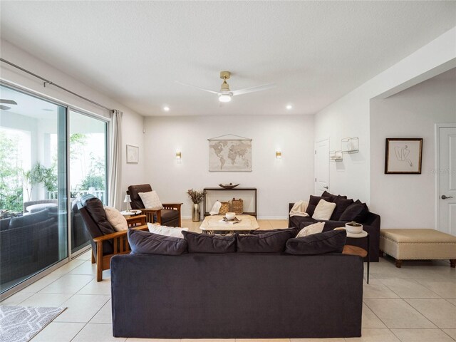 tiled living room with a textured ceiling and ceiling fan