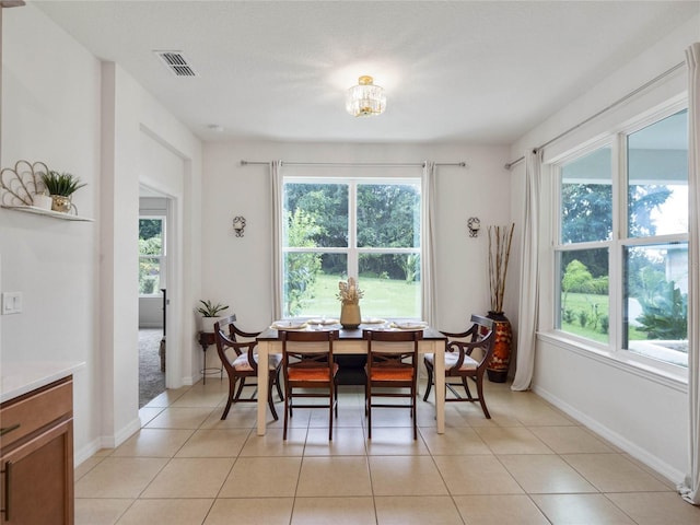 dining space with visible vents, baseboards, and light tile patterned flooring