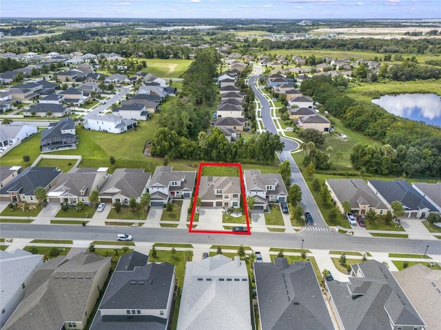 birds eye view of property with a residential view and a water view