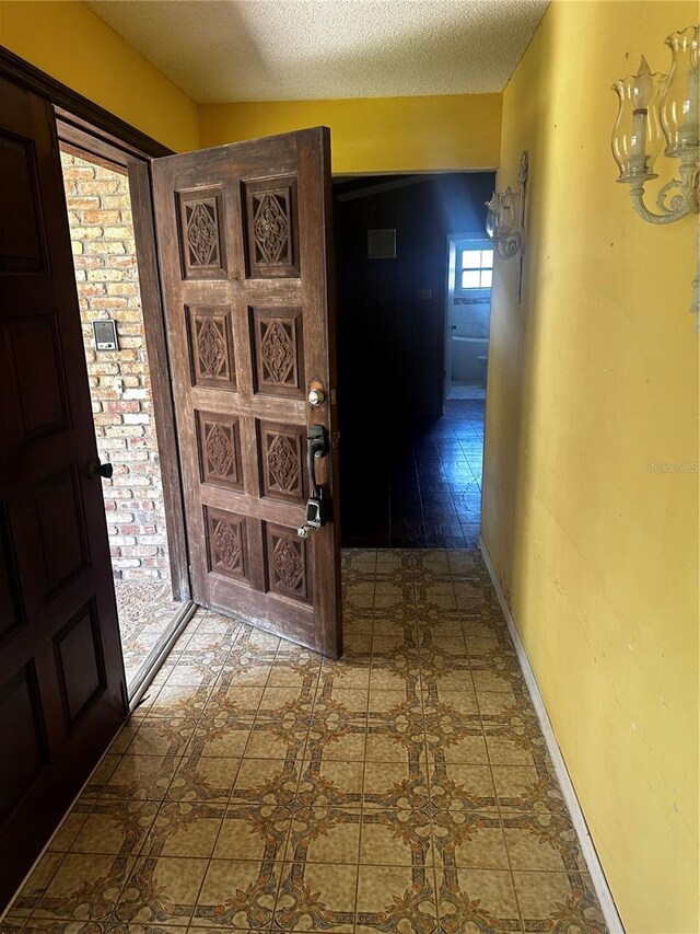 entrance foyer with tile patterned flooring and a textured ceiling