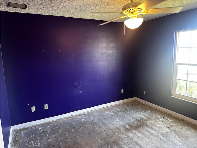 unfurnished room featuring ceiling fan and a textured ceiling