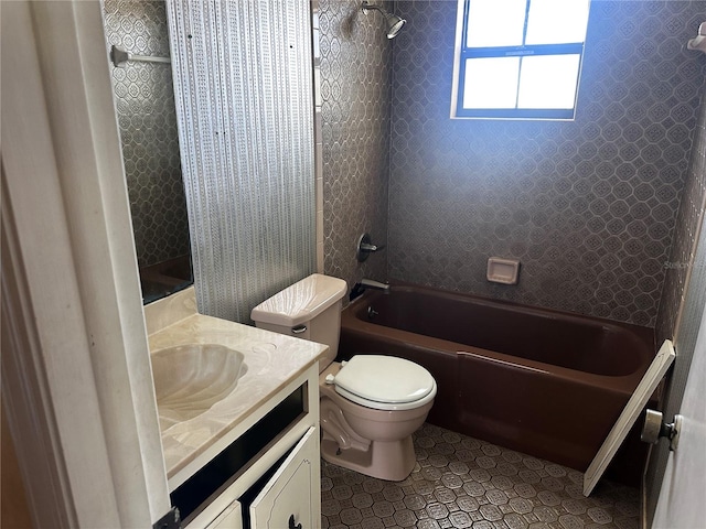 full bathroom with toilet, tiled shower / bath combo, vanity, and tile patterned floors