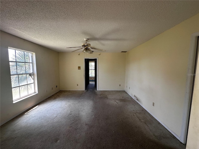 unfurnished room featuring ceiling fan, a textured ceiling, and carpet flooring