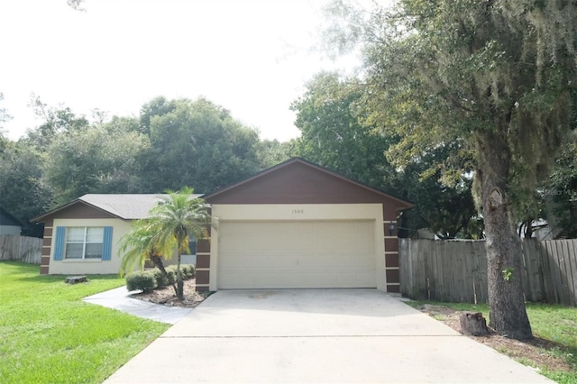 ranch-style home featuring a garage and a front lawn