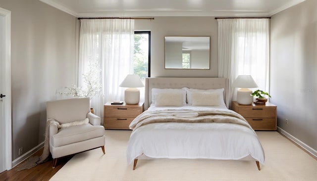 bedroom featuring light hardwood / wood-style floors and crown molding