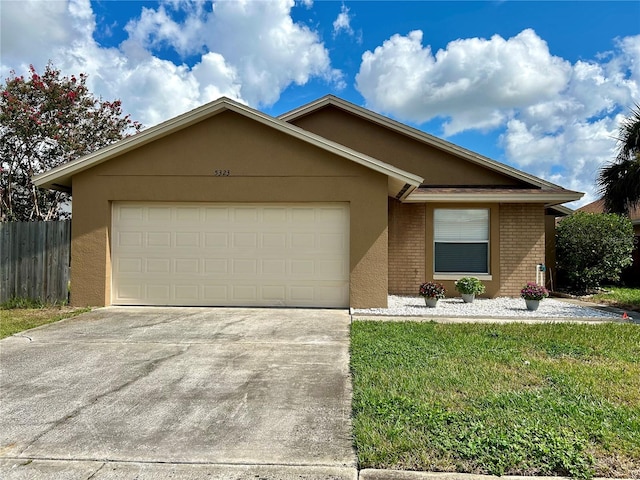 single story home with a front lawn and a garage