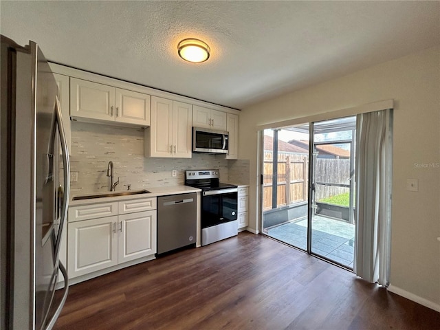 kitchen with a sink, stainless steel appliances, and white cabinets