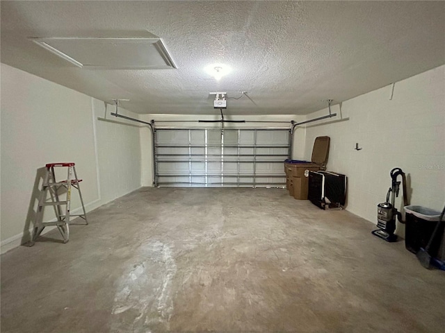 garage featuring concrete block wall and a garage door opener