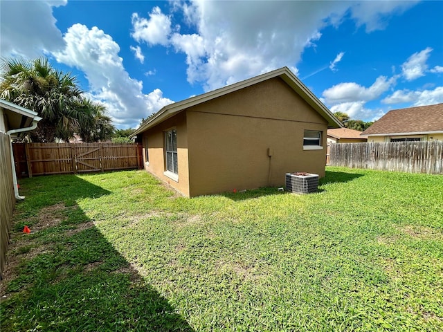 exterior space featuring a lawn, a fenced backyard, and stucco siding