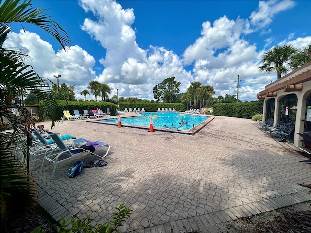 community pool with a patio area