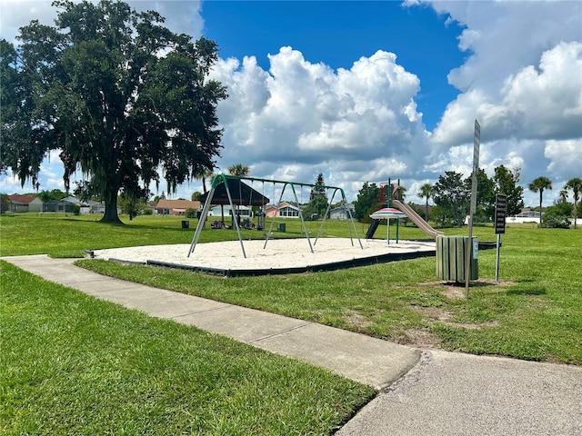 communal playground featuring a lawn