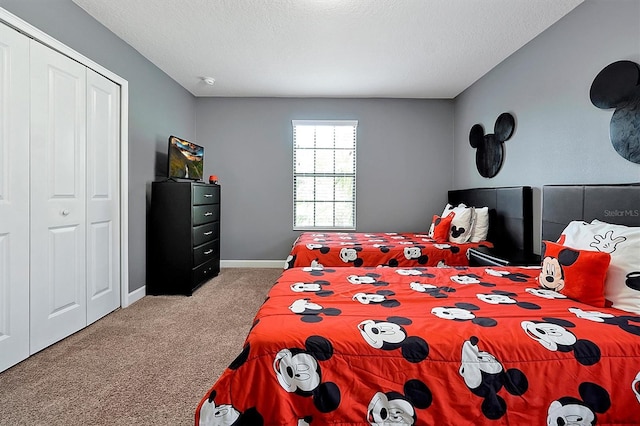 carpeted bedroom with a closet and a textured ceiling