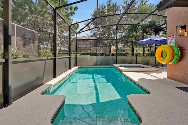 view of pool with an in ground hot tub, glass enclosure, and a patio