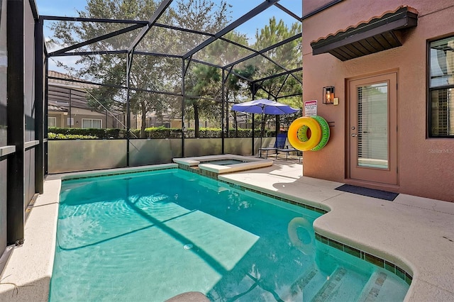 view of pool featuring glass enclosure, an in ground hot tub, and a patio