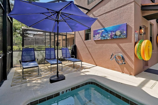 view of swimming pool with a hot tub, a lanai, and a patio