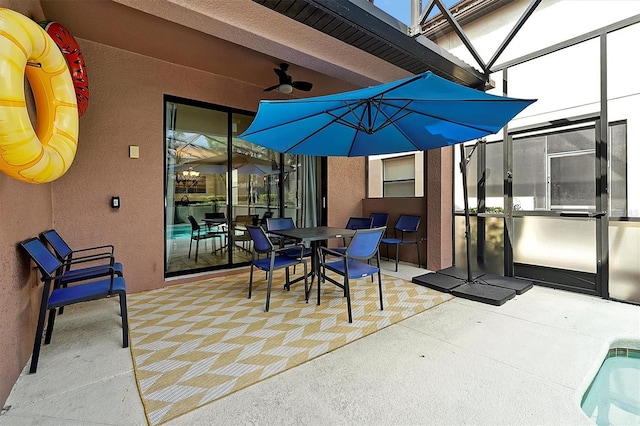 view of patio / terrace with ceiling fan, outdoor dining area, and a lanai