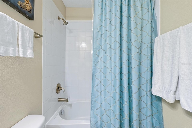 bathroom featuring toilet and shower / tub combo with curtain