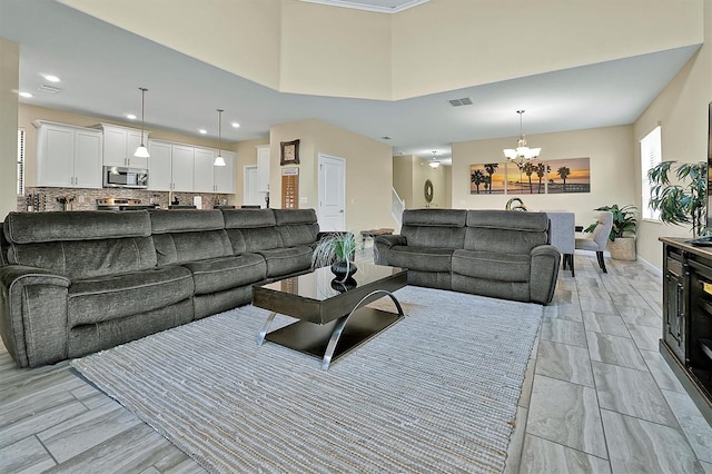 living room with light tile patterned floors and an inviting chandelier