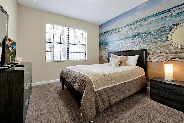 carpeted bedroom featuring wallpapered walls, an accent wall, and baseboards