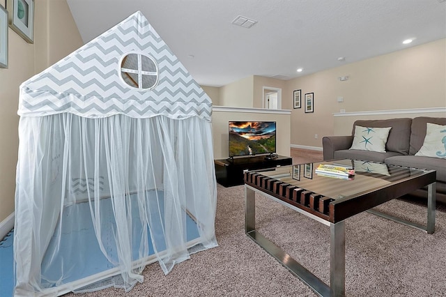 carpeted living room featuring recessed lighting and visible vents