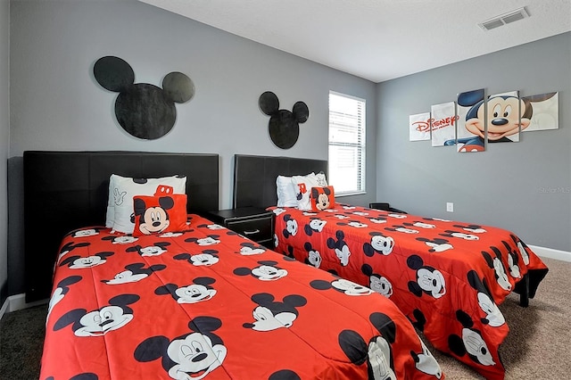 bedroom featuring visible vents, baseboards, and carpet