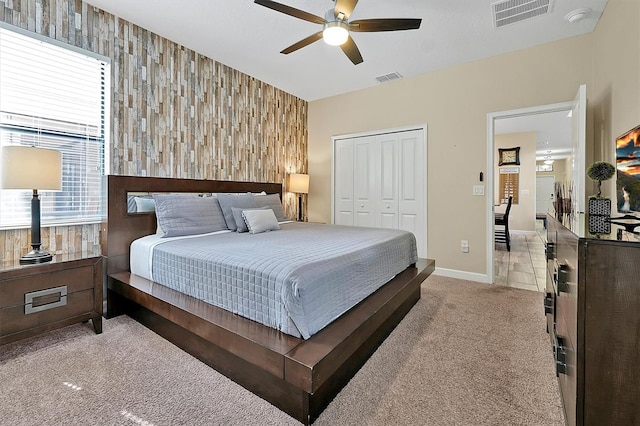 bedroom with a closet, ceiling fan, and light tile patterned floors