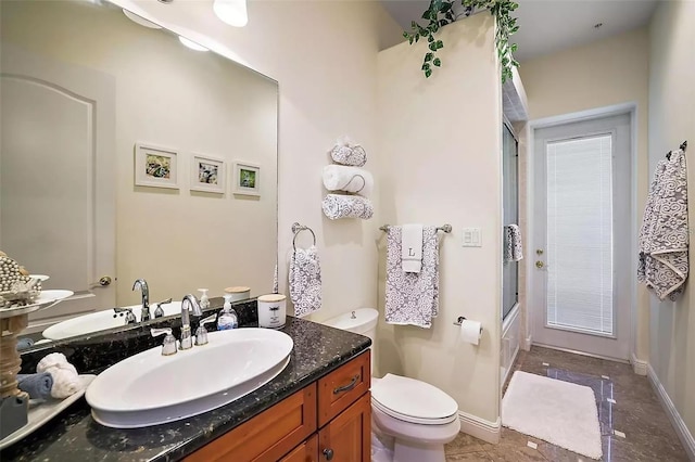 full bathroom with toilet, bath / shower combo with glass door, and vanity