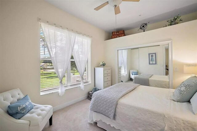 carpeted bedroom featuring a closet and ceiling fan