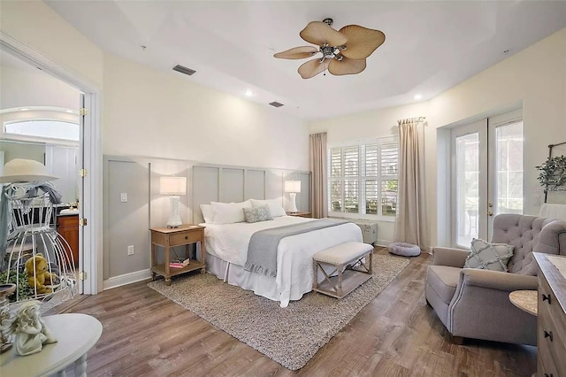 bedroom featuring access to exterior, wood-type flooring, and ceiling fan