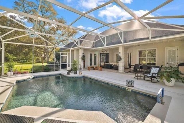 view of swimming pool with a patio area, glass enclosure, and outdoor lounge area