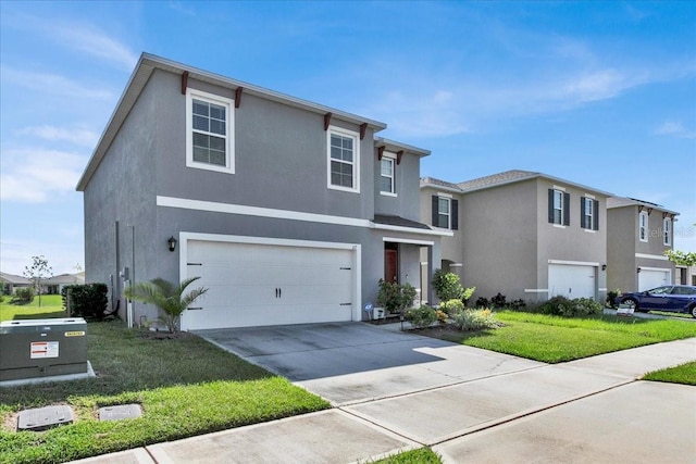 front of property with a garage and a front lawn