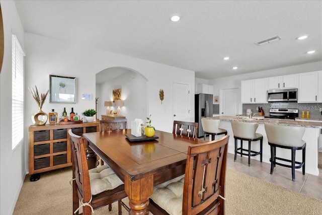 carpeted dining room with sink