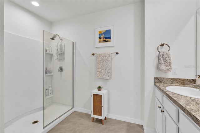 bathroom with walk in shower and vanity