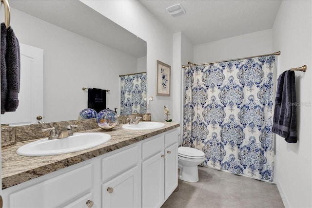 bathroom with tile patterned floors, curtained shower, vanity, and toilet