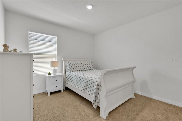 bedroom featuring light carpet