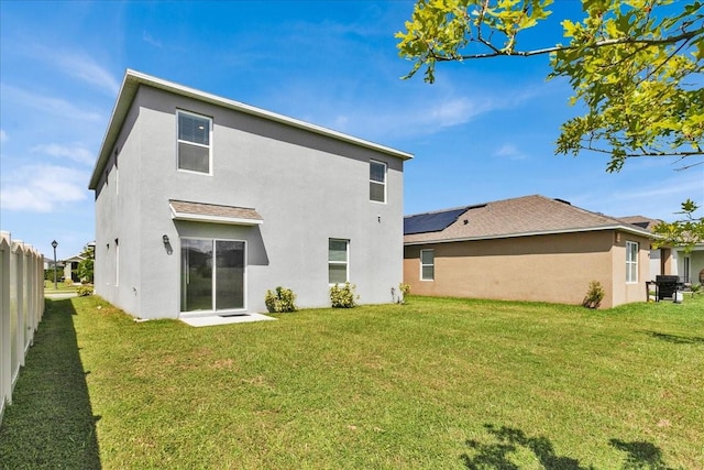 back of house featuring a lawn