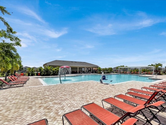 view of pool featuring pool water feature and a patio area