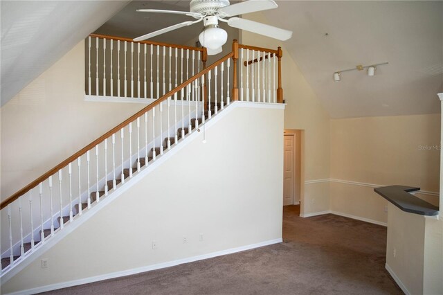 staircase featuring carpet flooring, ceiling fan, high vaulted ceiling, and rail lighting