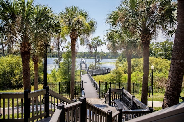 deck with fence and a water view