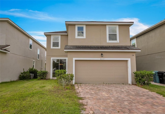 front of property featuring a front yard and a garage