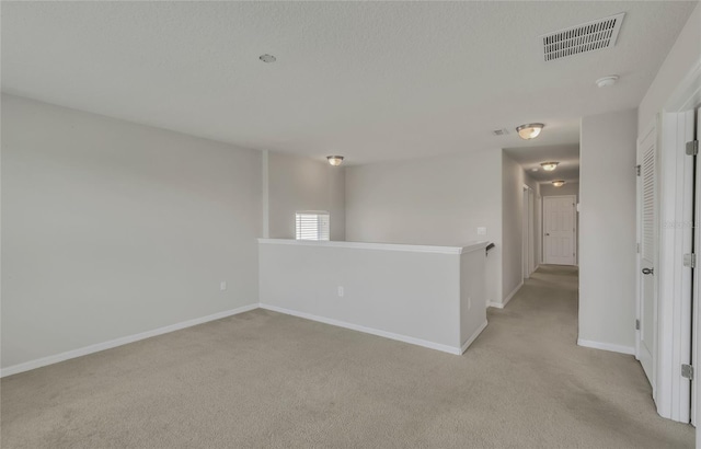 unfurnished room with light colored carpet