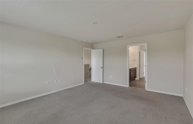 unfurnished bedroom with carpet and ensuite bathroom