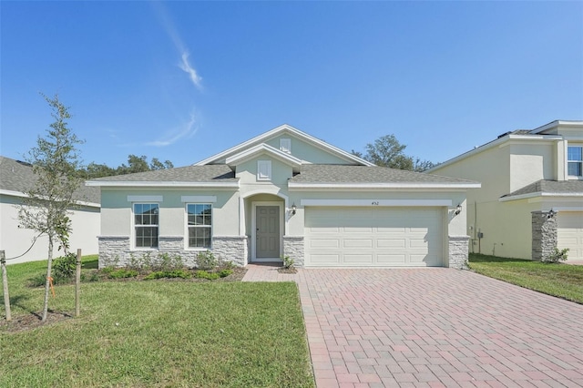 view of front of property featuring a garage and a front lawn